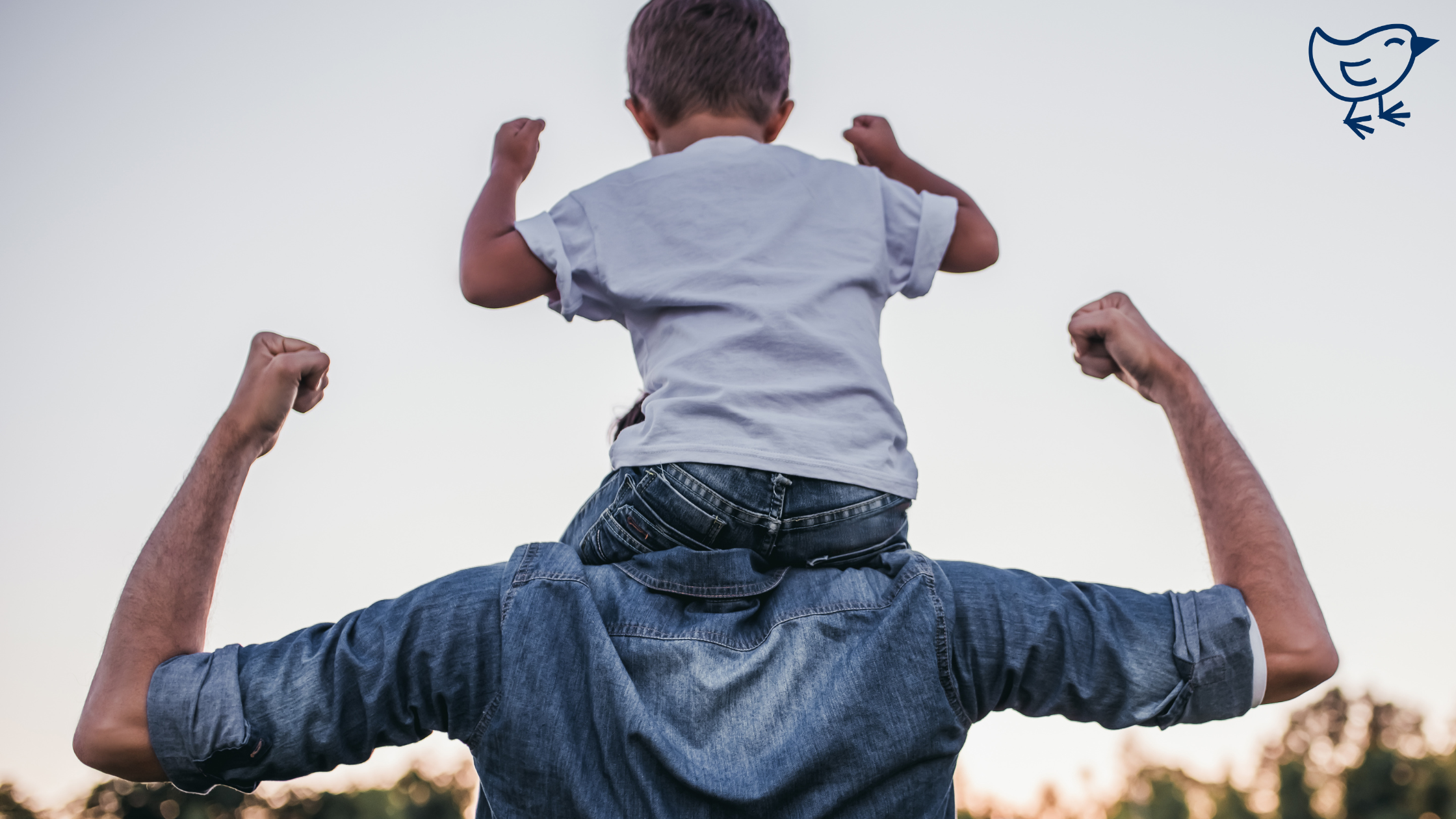 A man outdoors carrying a child on his shoulders. The child is wearing a white shirt, and both are dressed in casual clothing.