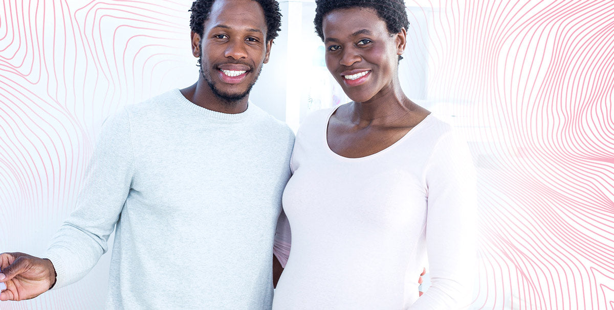 A man holding a paper roll and a woman, both smiling at the camera.