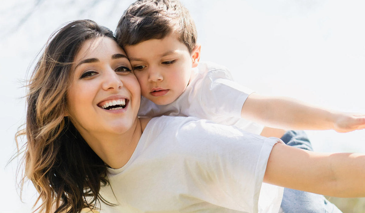 Brain Health, Immunity, Better Mood—Are You Getting Enough Vitamin D? Mom and son happy in sunshine