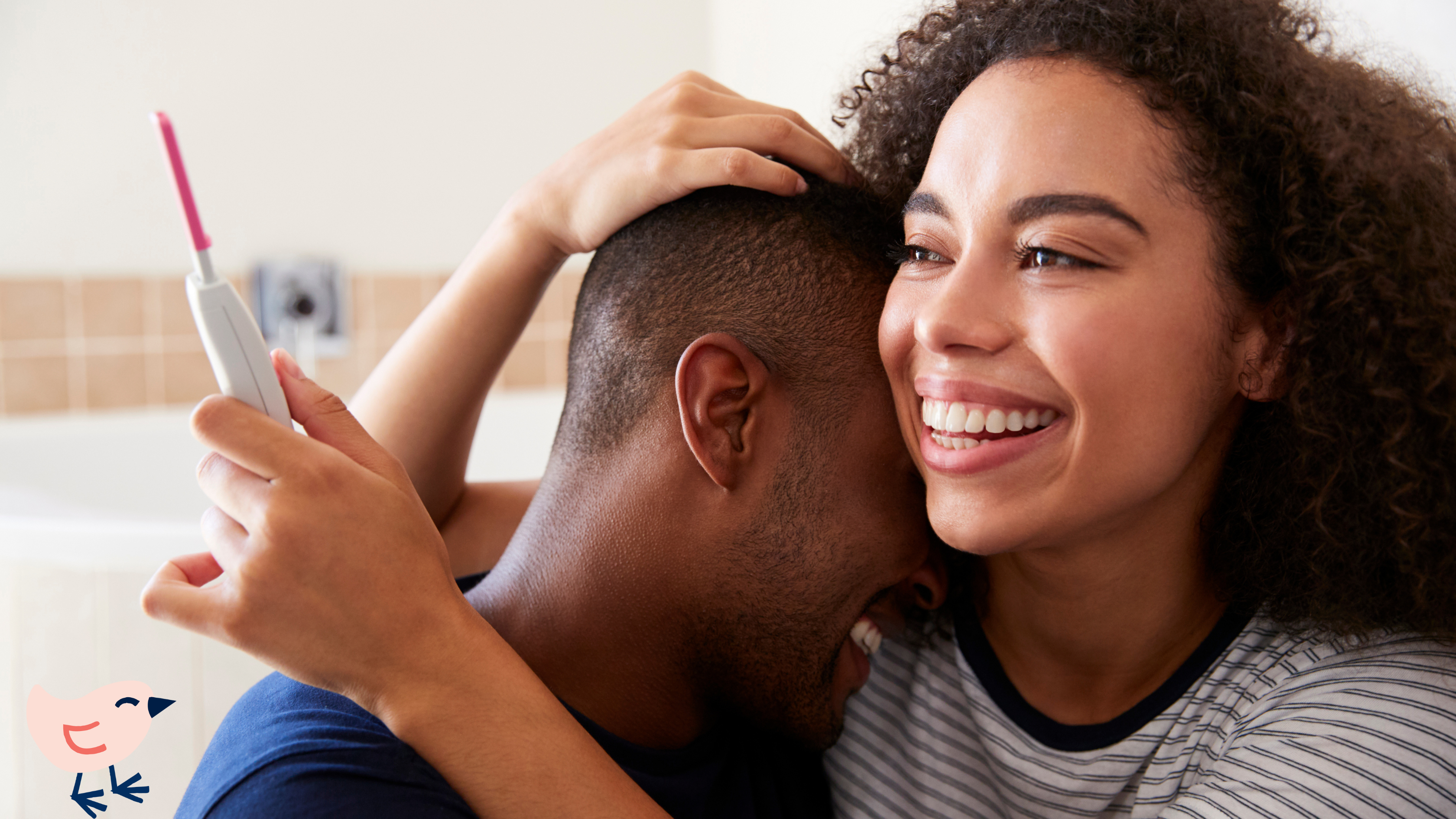 A man and woman hugging, both smiling, indoors. Close-up of their faces showing happiness and affection.