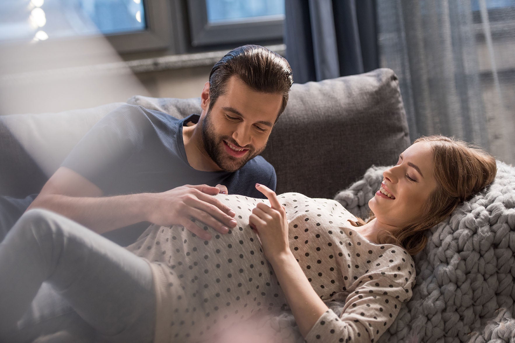 Your Immune System in Pregnancy, pregnant woman and man laying on couch