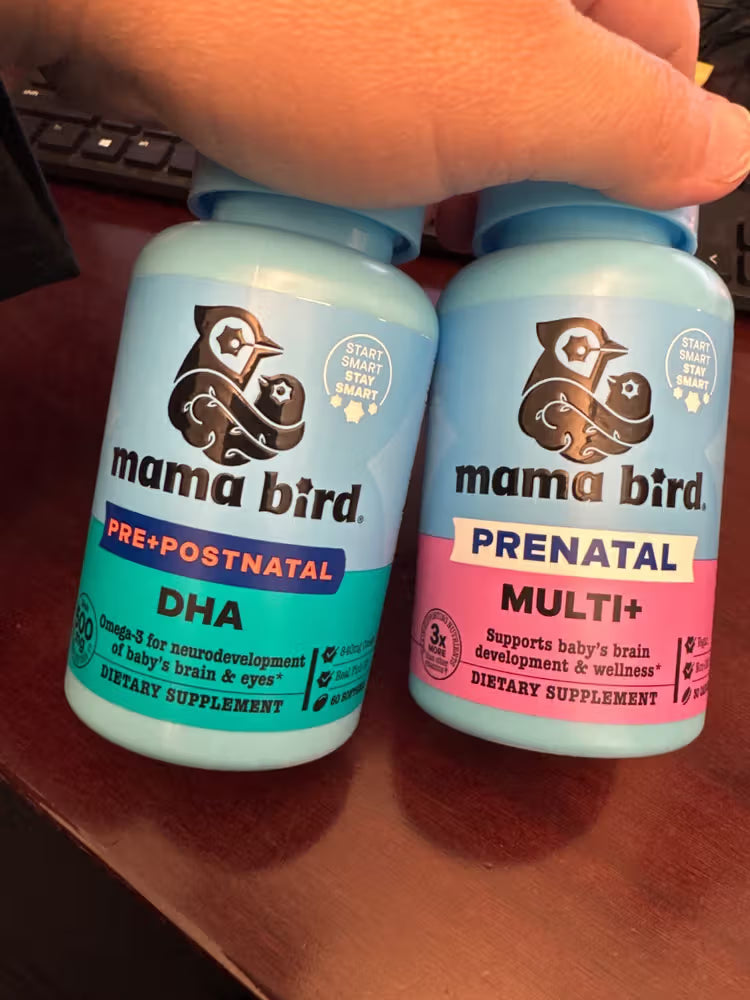 Two Mama Bird dietary supplement bottles on a wooden surface.